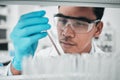 Lab scientist, test tube and face of man in laboratory studying chemical analysis, pharma research and vaccine Royalty Free Stock Photo