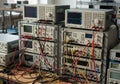 A lab setting with stacks of electronic testing equipment, including multiple oscilloscopes and Royalty Free Stock Photo