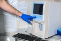 Lab technician adjusts device of very accurate medical blood test