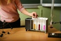 hand of chemistry teacher pulls out a test tube with colored liquid Royalty Free Stock Photo