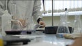 Lab technician doing experiment in lab. Male medical or scientific laboratory researcher performs tests with blue liquid Royalty Free Stock Photo