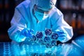 Lab technician examining biomaterial samples under microscope, analyzing cell structures Royalty Free Stock Photo