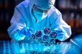 Lab technician examining biomaterial samples under microscope, analyzing cell structures