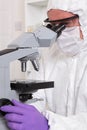 Lab technician focussing a microscope Royalty Free Stock Photo