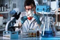 Lab technician holding tissue culture flask in the genetic labor