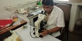 Lab technician looking into microscope at laboratory