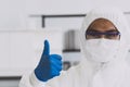 Lab Technician in Personal protective equipment PPE suit Good hand gesture