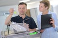 Lab technician with urine specimen on table Royalty Free Stock Photo