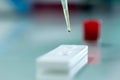 Close up view of pipette dropping serum specimen to test kit. Royalty Free Stock Photo