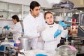 Lab technicians discussing during chemical experiment