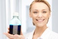 Lab worker holding up bottle with blue liquid Royalty Free Stock Photo