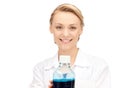 Lab worker holding up bottle with blue liquid Royalty Free Stock Photo