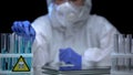 Lab worker inspecting test tubes with poison for sediments, dissolution process Royalty Free Stock Photo