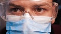 A lab worker in a mask puts on protective work glasses for working in laboratories. Concept of: Protective mask, Protective goggle Royalty Free Stock Photo