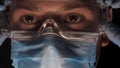 A lab worker in a mask puts on protective work glasses for working in laboratories. Concept of: Protective mask, Protective goggle Royalty Free Stock Photo