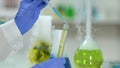 Lab worker mixing glycerol with chemical agent, detergent manufacturing, closeup