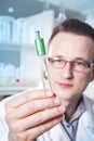 Lab worker observing test tube with mold at the laboratory