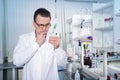 Lab worker observing test tube with mold at the laboratory