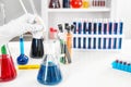 Lab worker taking sample from test tube with blue liquid on table Royalty Free Stock Photo