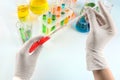 Lab worker taking sample from test tube with red liquid, closeup Royalty Free Stock Photo