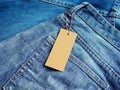 Label blank price tag mockup on blue jeans. Royalty Free Stock Photo