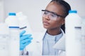 Label check tablet, chemical bottle and black woman scientist with mask at pharmaceutical lab. Research, digital reading