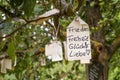 Label with wishes hangs in a tree