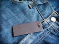 Label gray price tag mockup on blue jeans. Royalty Free Stock Photo