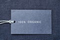 Label on linen fabric background. 100 percent organic materal Royalty Free Stock Photo