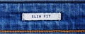 Close-up of a textile label with the inscription `Slim Fit` in banner format