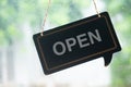 Label `OPEN` notice sign wood board hanging on door front coffee shop Royalty Free Stock Photo