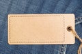 Label price tag mockup on blue jeans from recycled paper. Royalty Free Stock Photo