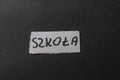 Label reading szkola, highlighting education theme on contrasting black background. Ideal for school-related projects, e Royalty Free Stock Photo