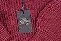 Label  saying `100% organic cotton` attached to environmental friendly produced pullover Royalty Free Stock Photo