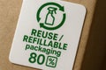 Label showing reuse and refillable packaging certification with 80 percent sustainability symbol on cardboard box Royalty Free Stock Photo