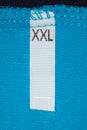 Label size XXL on blue cloth.