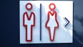 Label of symbol of toilet for men and women on concrete wall