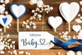 Label With White Decoration, Heart, Flower, Text Welcome Baby Royalty Free Stock Photo