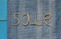 labeled sale of rope scourges on blue denim background