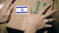 Labeling carton with the Israeli flag sticker. Import or export in Israel Royalty Free Stock Photo