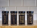 Labeled glass spice jars on the kitchen counter Royalty Free Stock Photo