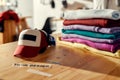 Labels that enhance your image. Custom apparel, clothes neatly folded on shelves. Stack of colorful clothing and