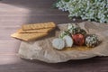 Labne balls with herbs and spices and crackers on kraft paper. Traditional yogurt cream cheese in the Middle East.