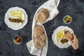 Labneh labaneh middle eastern soft white goat`s milk cheese with olive oil ,olives , za`atar , lemon, with pita bread over blac Royalty Free Stock Photo