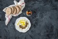 Labneh labaneh middle eastern soft white goat`s milk cheese with olive oil ,olives , za`atar , lemon, with pita bread over blac