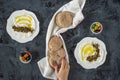 Labneh labaneh middle eastern soft white goat`s milk cheese with olive oil ,olives , za`atar , lemon, with woman hand holding o Royalty Free Stock Photo