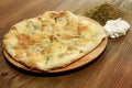 Labneh and thyme pie served in wooden board isolated on table side view of arabic food