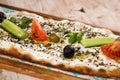 Labneh with zaatar pizza bread served in wooden board isolated on background top view of Arabic Manaqeesh