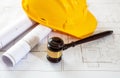 Labor, Construction law. Safety helmet and judge gavel on building blueprint