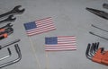 Labor Day in America, May 1. Many handy tools on concrete background with flag of America with copy space Royalty Free Stock Photo